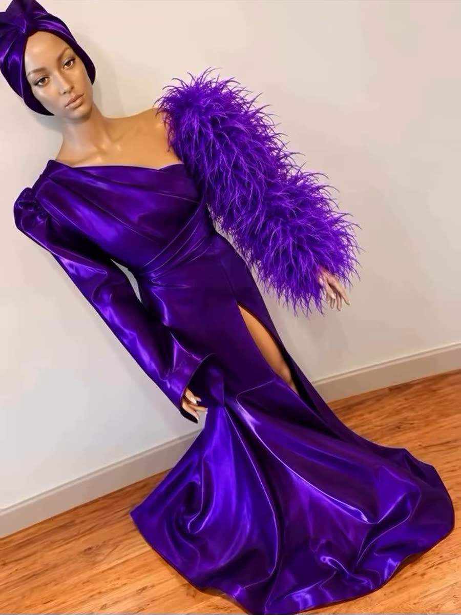 Purple one-shoulder gown with feather sleeve on a mannequin