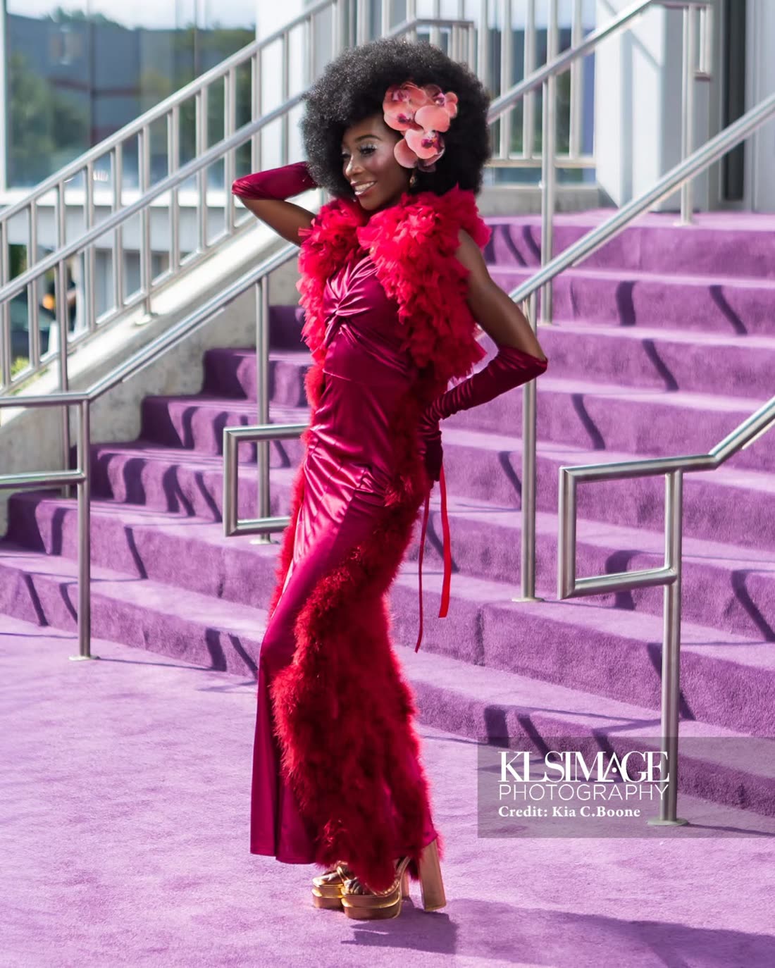 Red feather-trimmed gown, pose with hand behind the head